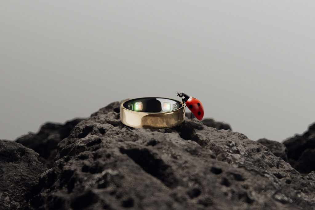 The ultra-slim titanium Oura Ring 5 sitting on a finger